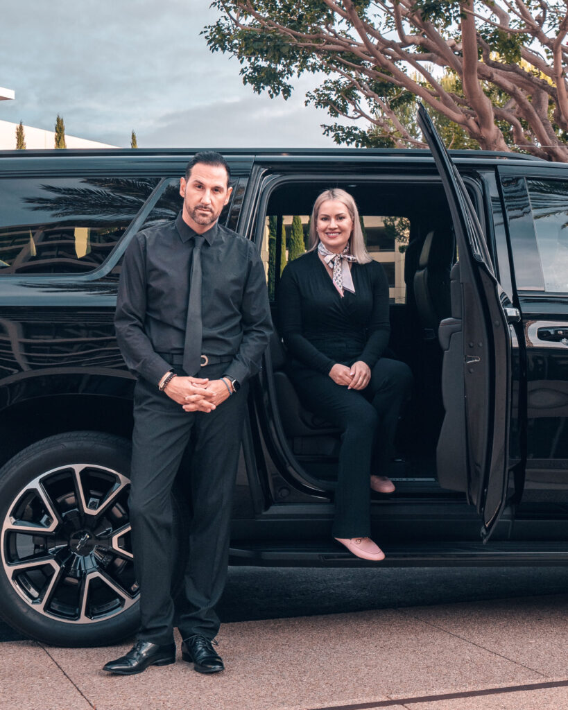 image of a chauffeur standing next to a SUV